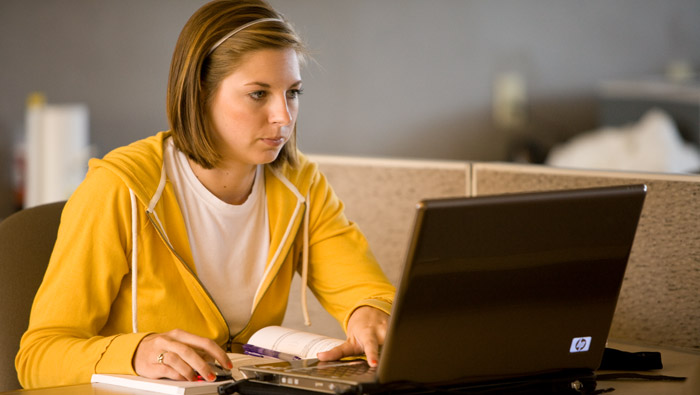 Student with laptop and books